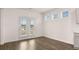 Bright living room features hardwood flooring and glass doors leading to the outside at 1129 Blue Juniper Cir, Loganville, GA 30052