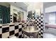 An elegant bathroom combines black and white tiles, mirrored walls, and seamless access to the bedroom and closet at 1130 Piedmont Ne Ave # 1407, Atlanta, GA 30309