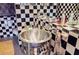 The bathroom features black and white tiles with a unique metal vessel sink and modern fixtures at 1130 Piedmont Ne Ave # 1407, Atlanta, GA 30309