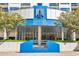 Elegant building entrance featuring a sleek glass facade and prominent signage, with manicured landscaping at 1130 Piedmont Ne Ave # 1407, Atlanta, GA 30309