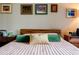 Relax in the main bedroom featuring soft lighting, plush pillows, and colorful wall art at 1130 Piedmont Ne Ave # 1407, Atlanta, GA 30309