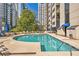 Outdoor pool area with lounge chairs, tables, and city views at 1130 Piedmont Ne Ave # 1407, Atlanta, GA 30309