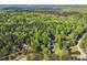 Scenic aerial view of a wooded property with homes nestled among lush greenery at 3541 Hutcheson Ferry Rd, Whitesburg, GA 30185