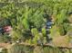 Aerial view of the home surrounded by lush greenery, showcasing the property's privacy at 3541 Hutcheson Ferry Rd, Whitesburg, GA 30185