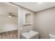 Neutral toned bathroom with a sink and mirror featuring wood-look flooring and access to the bedroom at 3541 Hutcheson Ferry Rd, Whitesburg, GA 30185