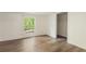 This bedroom features wood-look flooring, fresh paint, and a closet with outside views at 3541 Hutcheson Ferry Rd, Whitesburg, GA 30185