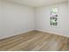 Bedroom with wood-look floors and a window provides ample natural light at 3541 Hutcheson Ferry Rd, Whitesburg, GA 30185