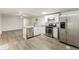 Kitchen with white cabinets, stainless steel appliances, and laminate floors at 3541 Hutcheson Ferry Rd, Whitesburg, GA 30185