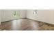 This living room features wood-look flooring, fresh paint, and access to the outside via glass paneled doors at 3541 Hutcheson Ferry Rd, Whitesburg, GA 30185