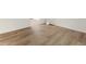 An open living space featuring wood-look flooring, fresh paint, and lots of natural light at 3541 Hutcheson Ferry Rd, Whitesburg, GA 30185