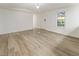 Living room featuring laminate wood floors and neutral color at 3541 Hutcheson Ferry Rd, Whitesburg, GA 30185