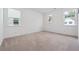 A bright bedroom with carpet flooring and two windows that provide natural light at 4143 Halton Rd, Duluth, GA 30097