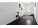 Bright entryway with wood floors, white walls, decorative accents, and a glass paneled front door at 4143 Halton Rd, Duluth, GA 30097