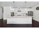 Kitchen featuring a large center island with pendant lighting, white cabinets and stainless steel appliances at 4143 Halton Rd, Duluth, GA 30097