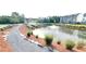 Community walking trail near a pond with a water fountain and bench at 4143 Halton Rd, Duluth, GA 30097