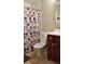 Bathroom featuring white toilet and tiled tub-shower combo with cherry wood vanity at 1804 Huntingdon Chase # 1804, Atlanta, GA 30350