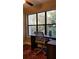 Bright home office with large window and wooded view, complete with ceiling fan and decorative area rug at 1804 Huntingdon Chase # 1804, Atlanta, GA 30350