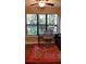 Charming home office features a picturesque view through a large window, paired with a ceiling fan and decorative area rug at 1804 Huntingdon Chase # 1804, Atlanta, GA 30350