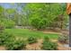 Lush backyard with manicured lawn and mature trees providing shade and privacy at 2060 Pate Ridge Dr, Loganville, GA 30052