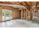 Spacious unfinished basement with exposed beams and door to the backyard at 2060 Pate Ridge Dr, Loganville, GA 30052