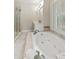 Well-lit bathroom featuring a soaking tub with tile surround and a separate glass-enclosed shower at 2060 Pate Ridge Dr, Loganville, GA 30052
