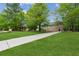 Exterior view featuring a long driveway leading to the side-entry garage on a spacious, green lawn at 2060 Pate Ridge Dr, Loganville, GA 30052