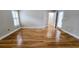 Hallway featuring shiny hardwood flooring, white trim, and access to a door with sidelight window at 2060 Pate Ridge Dr, Loganville, GA 30052