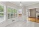 Sun-drenched breakfast nook with large windows and white trim and access to fireplace area at 2060 Pate Ridge Dr, Loganville, GA 30052