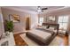 Spacious main bedroom with hardwood floors, tray ceiling, plantation shutters, and neutral color palette at 2060 Pate Ridge Dr, Loganville, GA 30052