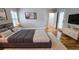 Comfortable main bedroom with hardwood floors, plantation shutters, neutral color palette, and ensuite access at 2060 Pate Ridge Dr, Loganville, GA 30052