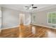 Spacious main bedroom with hardwood floors, tray ceiling, plantation shutters, and neutral color palette at 2060 Pate Ridge Dr, Loganville, GA 30052