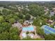 Aerial view of a community with a large pool and tennis courts surrounded by trees at 2305 Whiting Bay Cts, Kennesaw, GA 30152