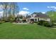 Expansive backyard with lush green lawn, mature trees, pool, and outdoor living space at 2305 Whiting Bay Cts, Kennesaw, GA 30152