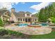 Backyard oasis with a luxurious pool, water feature, and stone pool house at 2305 Whiting Bay Cts, Kennesaw, GA 30152