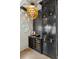 Stylish bar area with custom cabinets, a wine cooler, and unique lighting fixture at 2305 Whiting Bay Cts, Kennesaw, GA 30152