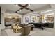 Basement living area with a stone accent wall, cozy seating, and a stylish bar area with unique light fixtures at 2305 Whiting Bay Cts, Kennesaw, GA 30152