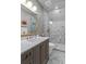 Stylish bathroom with a marble countertop, soft grey cabinetry, gold hardware, and a glass-enclosed shower at 2305 Whiting Bay Cts, Kennesaw, GA 30152
