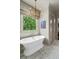Bright bathroom with free-standing tub, chandelier and tiled floors at 2305 Whiting Bay Cts, Kennesaw, GA 30152