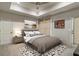 Comfortable bedroom features tray ceiling, ceiling fan, and natural light at 2305 Whiting Bay Cts, Kennesaw, GA 30152