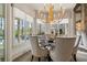 Dining room featuring an elegant chandelier and view of the pool, blending luxury with relaxation at 2305 Whiting Bay Cts, Kennesaw, GA 30152