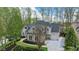 Aerial view of a beautiful home with pristine landscaping and a driveway at 2305 Whiting Bay Cts, Kennesaw, GA 30152