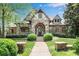 Charming stone and brick home with manicured landscaping, showcasing a welcoming facade and entryway at 2305 Whiting Bay Cts, Kennesaw, GA 30152