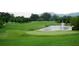 Beautiful golf course featuring a pond, fountain, and well-maintained greens, creating a scenic landscape at 2305 Whiting Bay Cts, Kennesaw, GA 30152