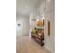 Hallway with bench seating, storage cabinets, art display and hardwood floors at 2305 Whiting Bay Cts, Kennesaw, GA 30152