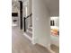 Well-lit hallway with wood flooring and stairway at 2305 Whiting Bay Cts, Kennesaw, GA 30152