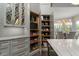 Spacious pantry with custom shelving, drawers, stainless appliances, and easy access to kitchen and dining area at 2305 Whiting Bay Cts, Kennesaw, GA 30152