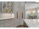 Custom kitchen with large cabinets, gold hardware, marble countertops, stainless appliances, and adjacent dining area at 2305 Whiting Bay Cts, Kennesaw, GA 30152