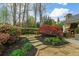Stone walkway through well-manicured landscaping and trees at 2305 Whiting Bay Cts, Kennesaw, GA 30152