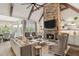 Open-concept living room with stone fireplace, high ceilings, large windows, and adjacent dining area with lots of space at 2305 Whiting Bay Cts, Kennesaw, GA 30152