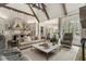 Open-concept living room features large windows, coffered ceilings, kitchen, and dining area with lots of space at 2305 Whiting Bay Cts, Kennesaw, GA 30152